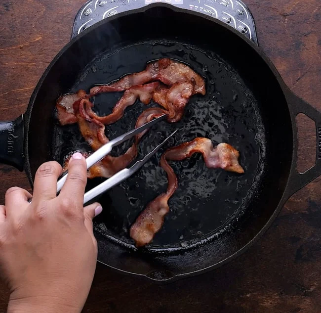 Bacon cooking in skillet.