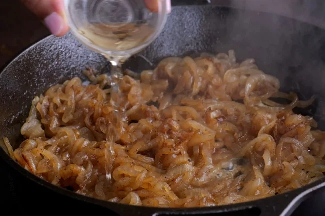 Sherry being added to pan.