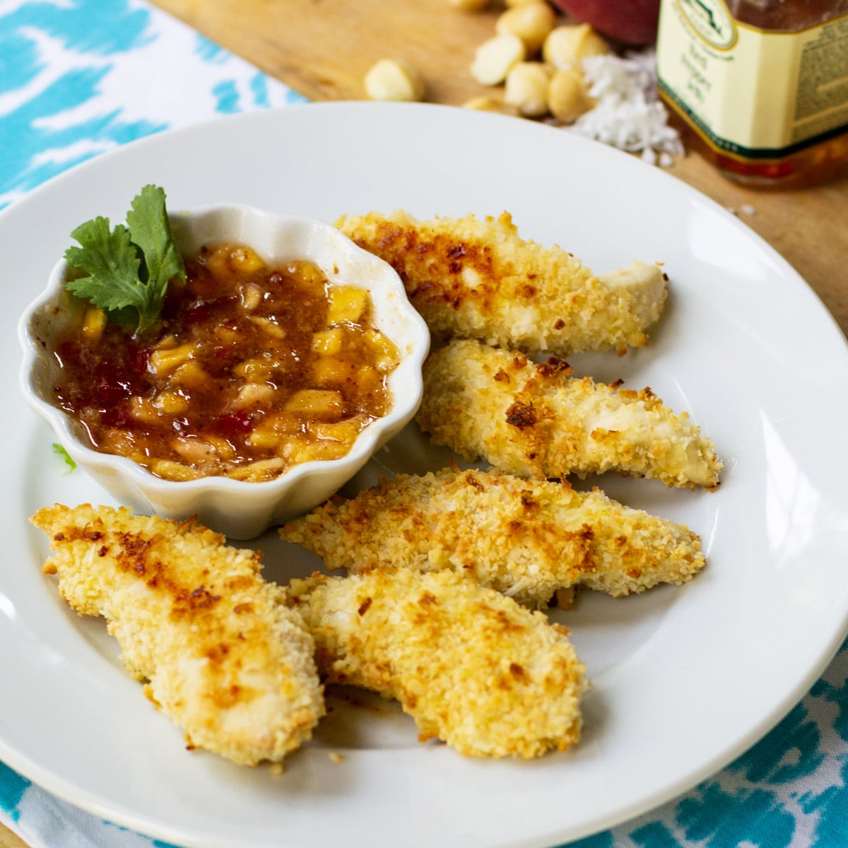 Coconut Macadamia Chicken Tenders on plate with peach red pepper jelly.