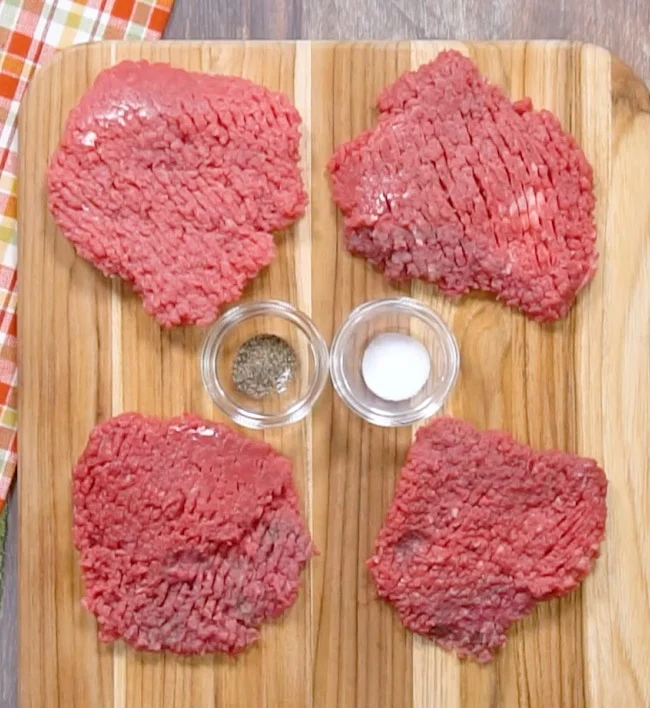 Seasoning the cubed steak.