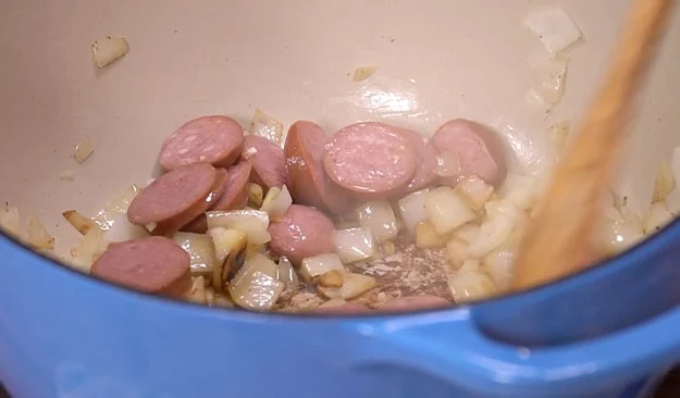 Cooking the sausage and garlic.
