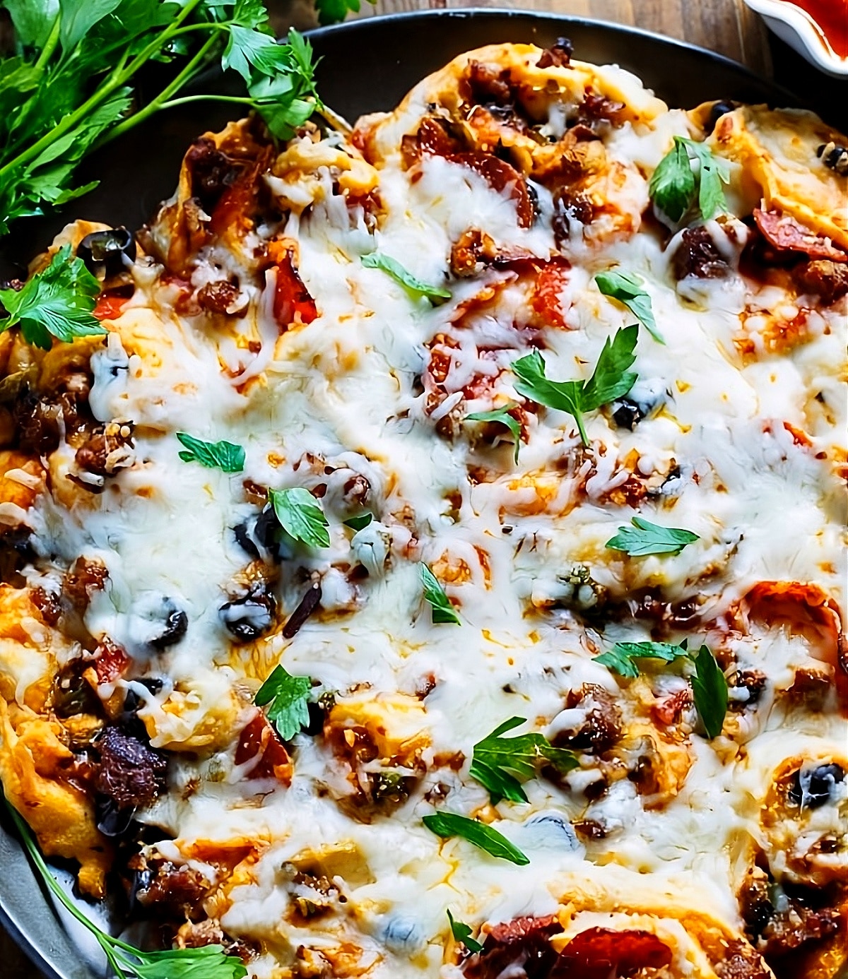 Pull-Apart Supreme Pizza Pinwheels on a pizza pan.