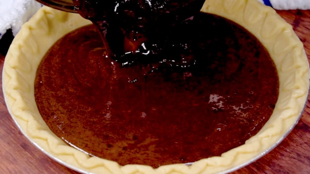 Pouring batter into pie crust.