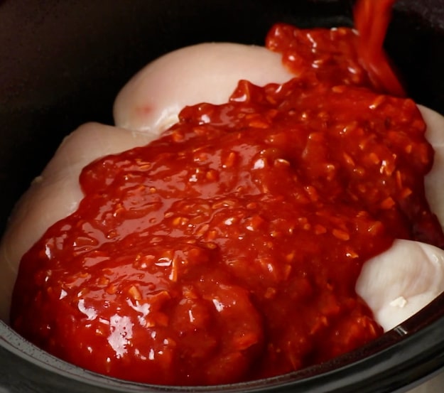 Pouring sauce over chicken.