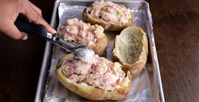 Stuffing the potatoes.