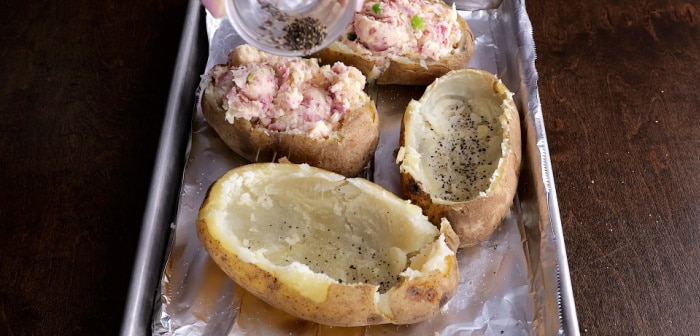 Seasoning the potato skins.