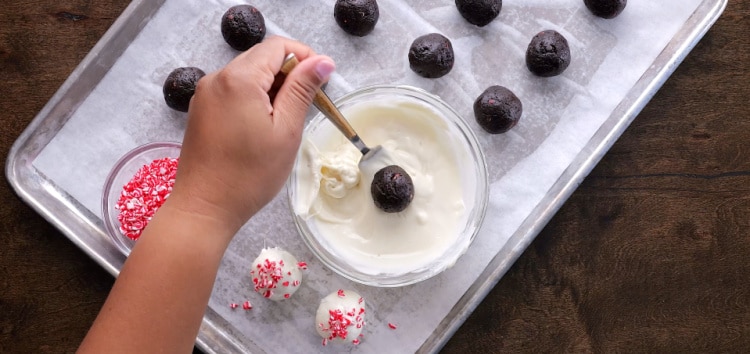 Dipping into melted white chocolate.