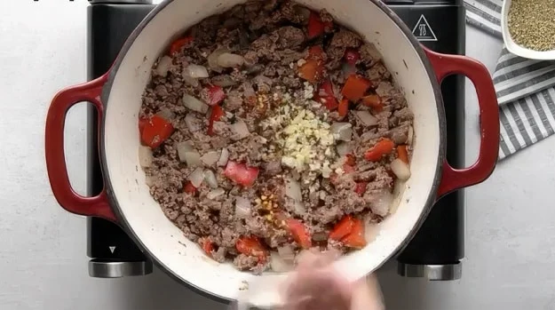 Adding garlic.