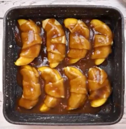 Butter mixture spooned over crescents.