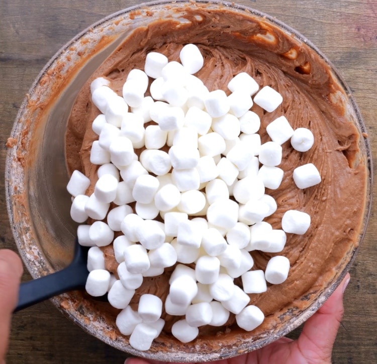 Stirring in marshmallows.