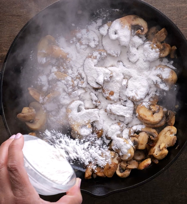 Adding flour to pan.