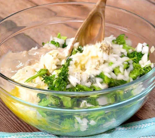 Mixing broccoli mixture together.