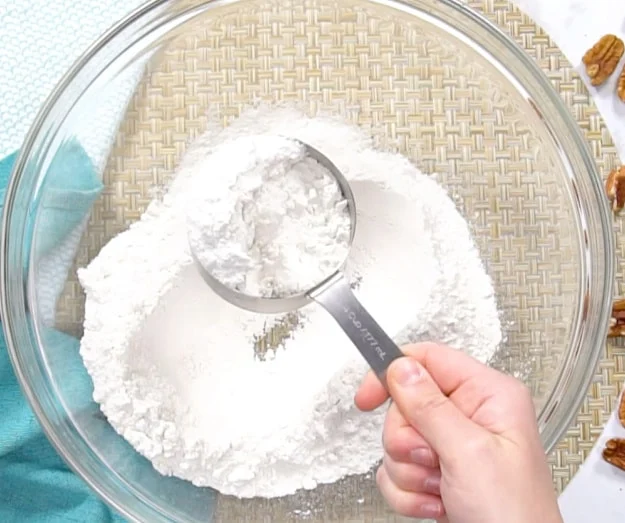 Measuring out cake mix.
