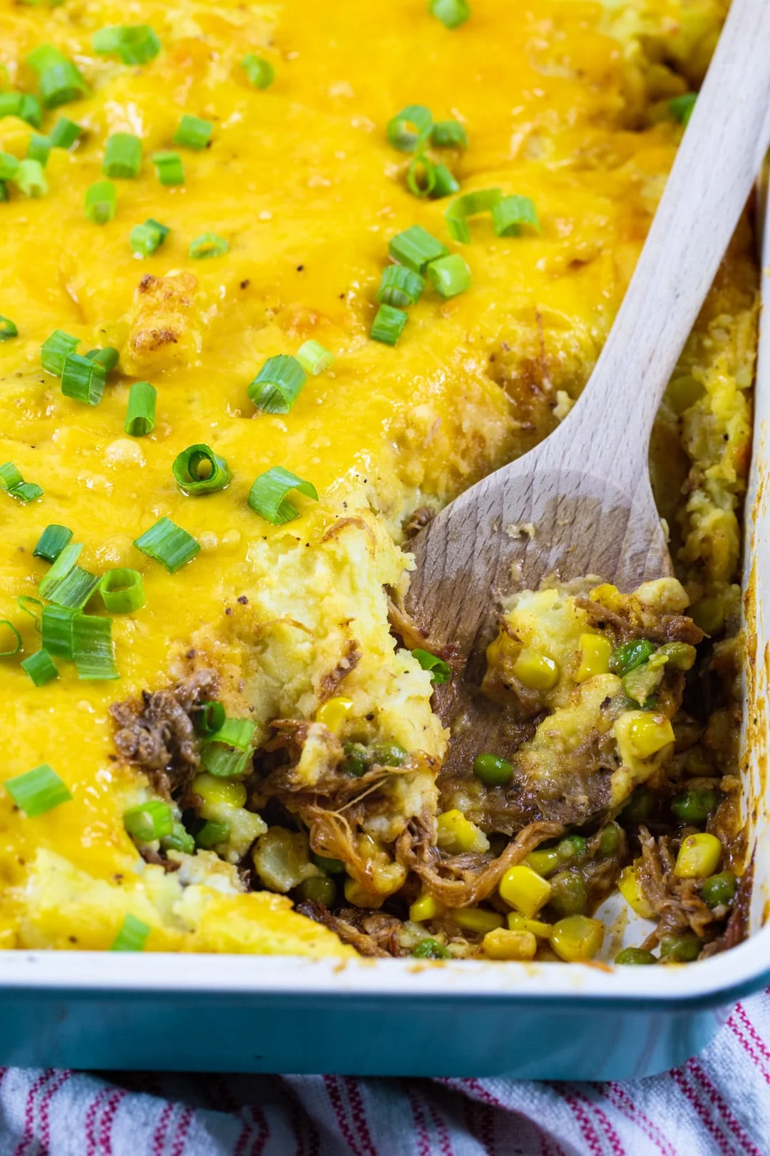Wooden spoon scooping Shepherd's Pie