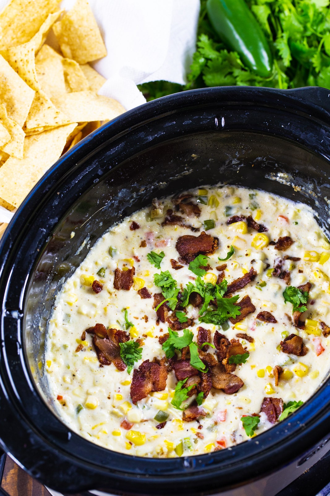 Jalapeno Popper Corn Dip in a black slow cooker.