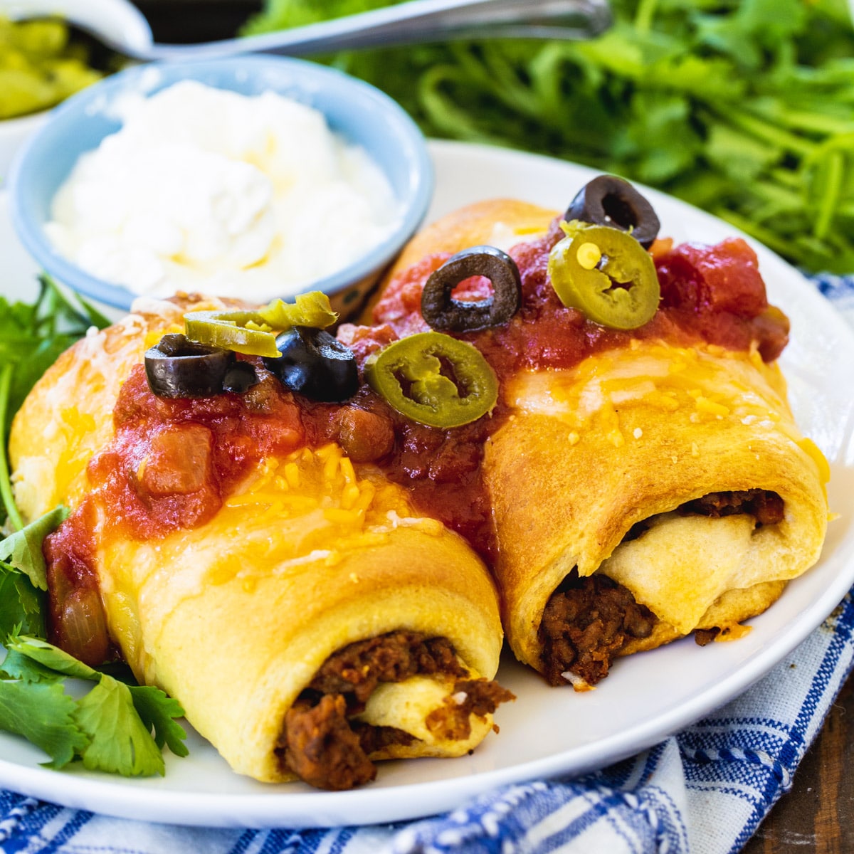 Two Crescent Beef Burritos on a plate.