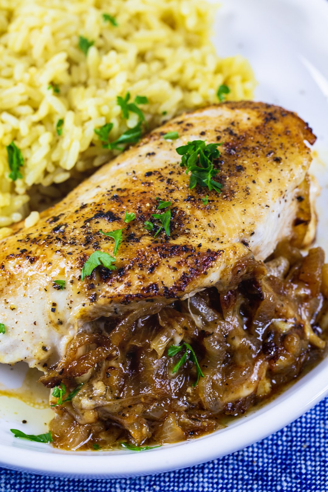 Stuffed Chicken Breast on plate with yellow rice.