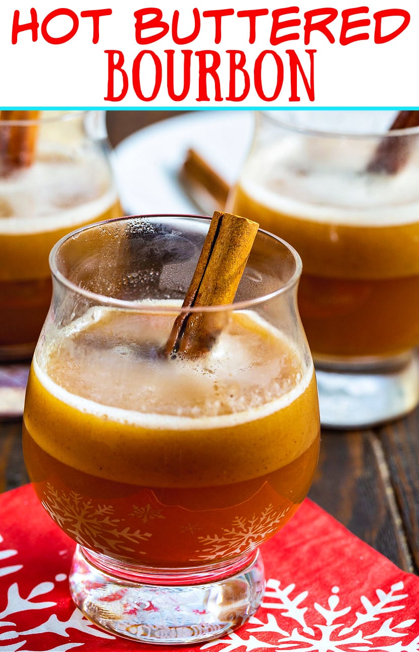 Hot Buttered Bourbon in a glass with a cinnamon stick.
