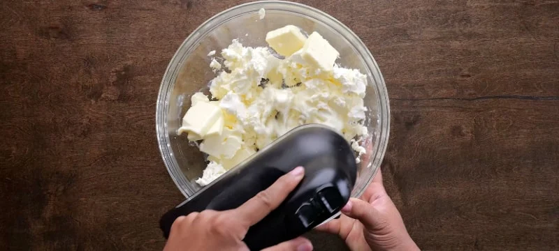 Creaming butter and cream cheese.