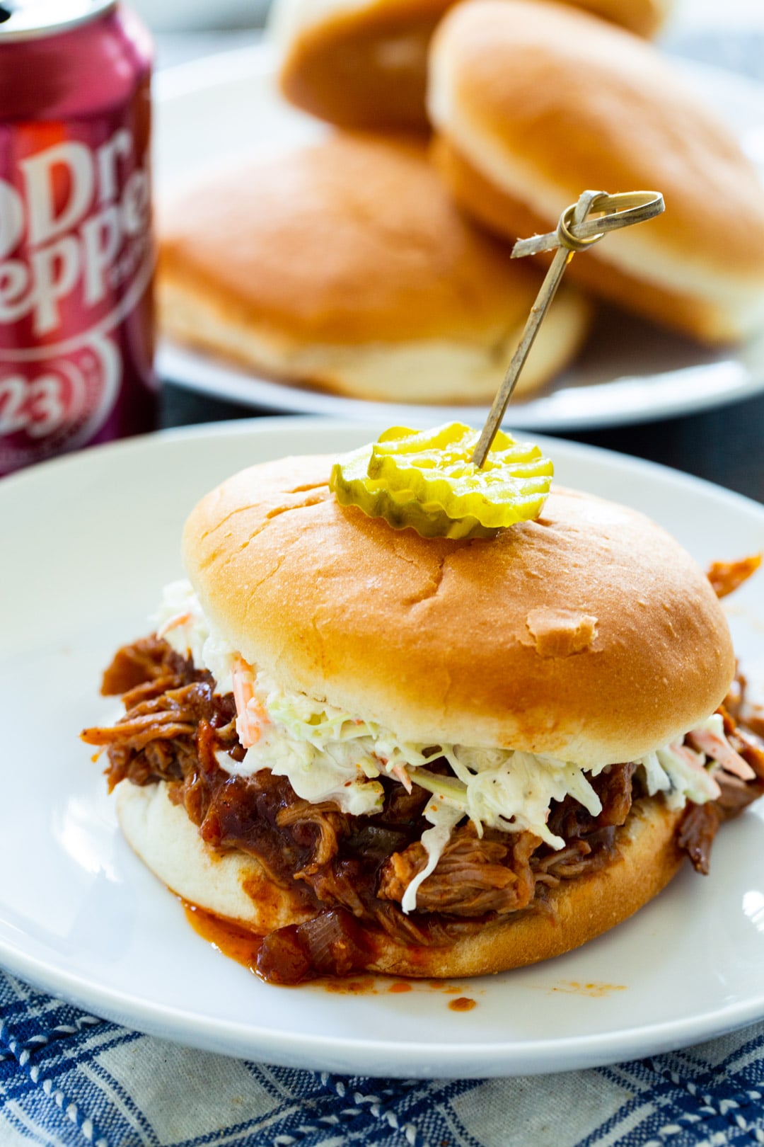 Slow Cooker Dr. Pepper Pulled Pork on a bun with coleslaw.