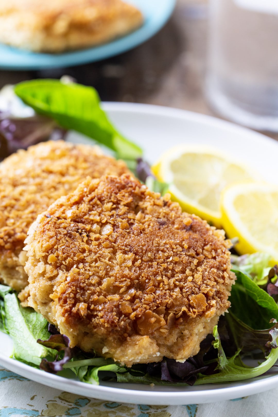 Southern Salmon Patties on a plate with lettuce and lemon slices.