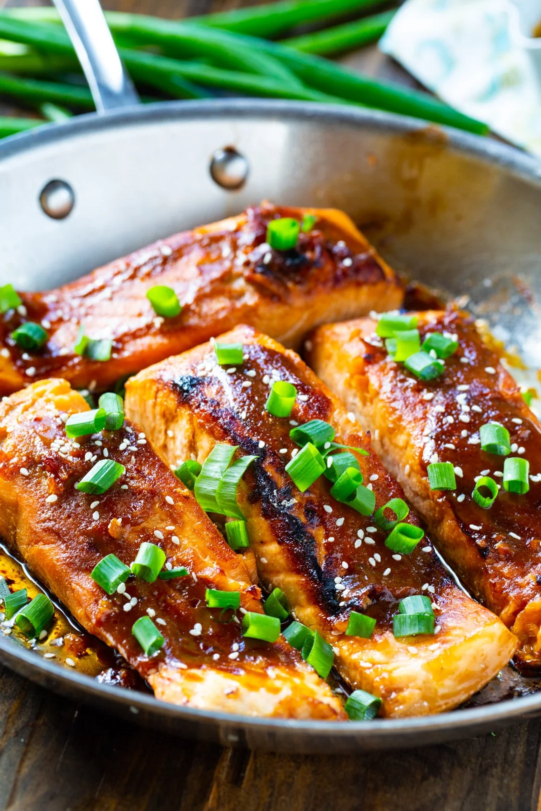 Cooked salmon in a stainless steel pan.