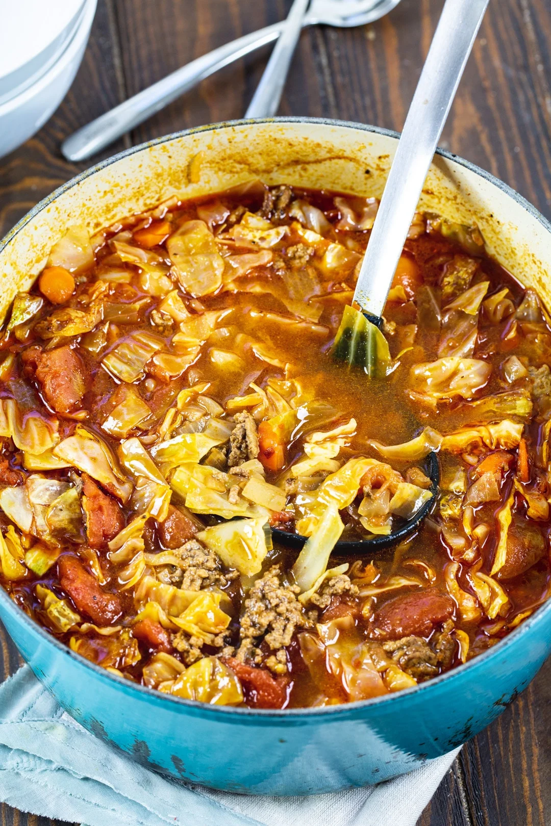 Spoon scopping soup out of Dutch oven.