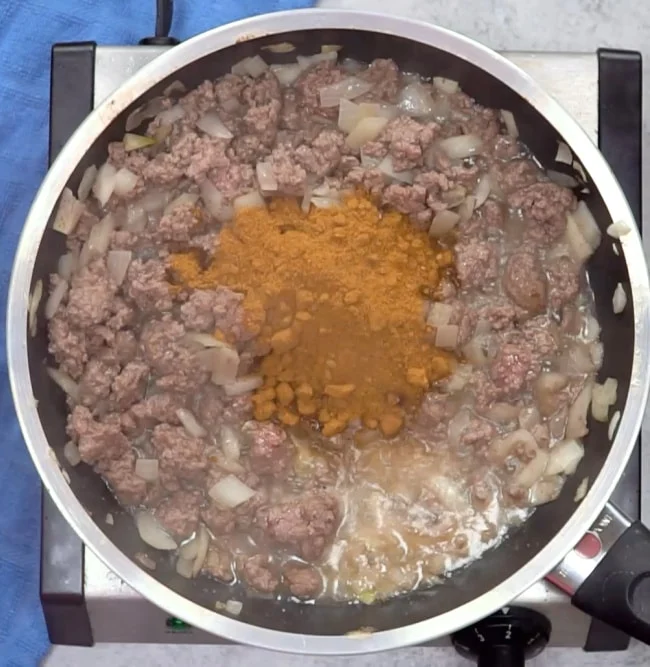 Adding taco seasoning.