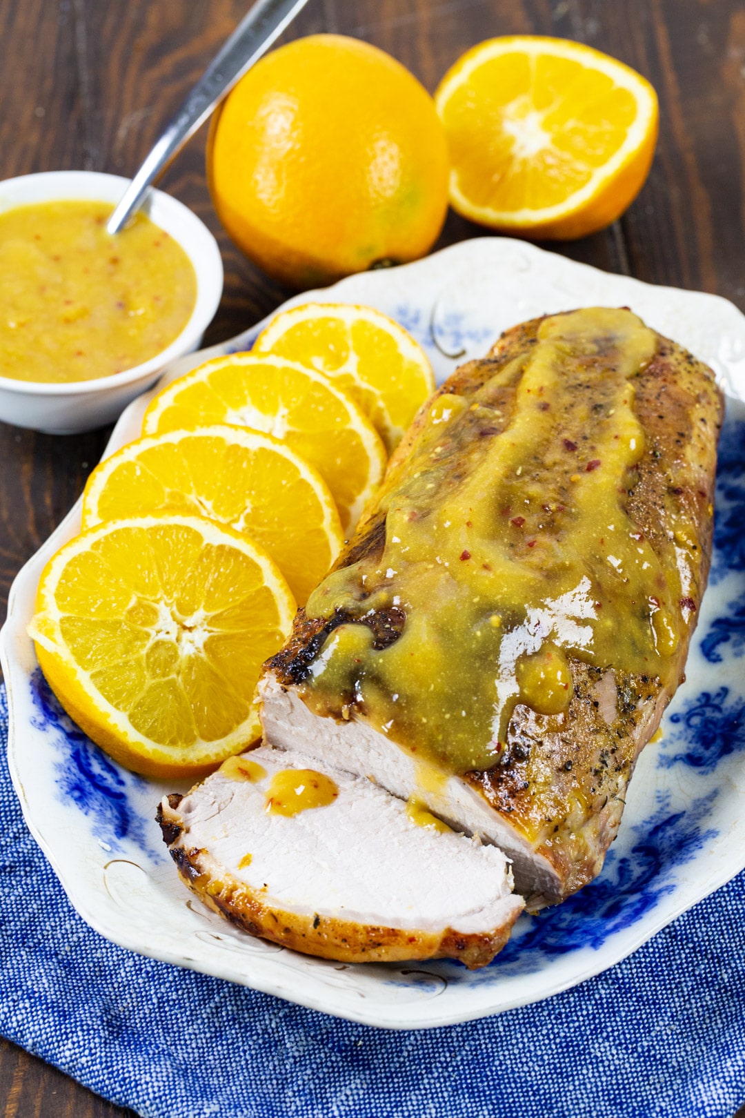 Pork Loin with orange glaze on a serving platter with orange slices.