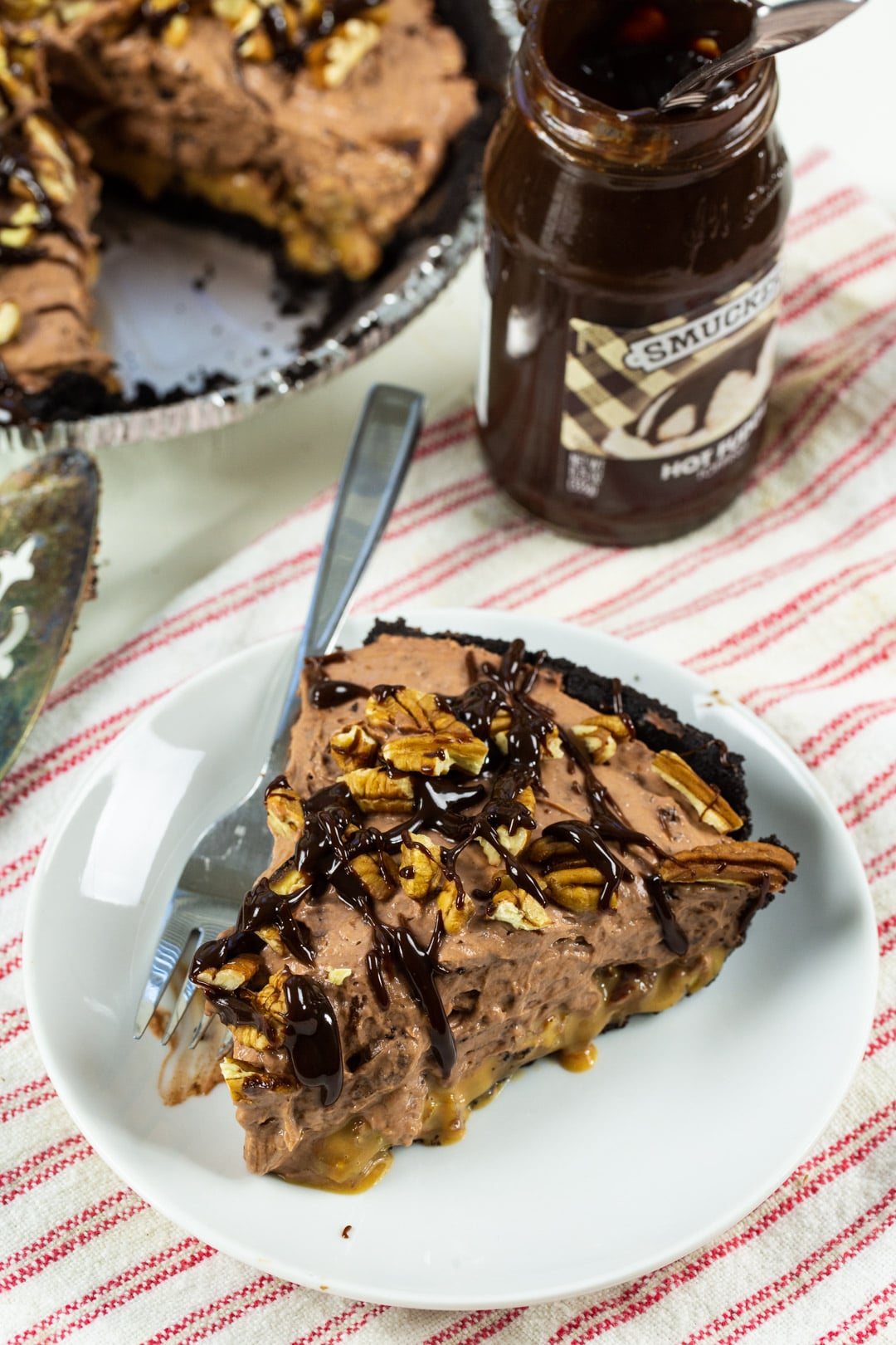 Pie slice drizzled with fudge sauce.