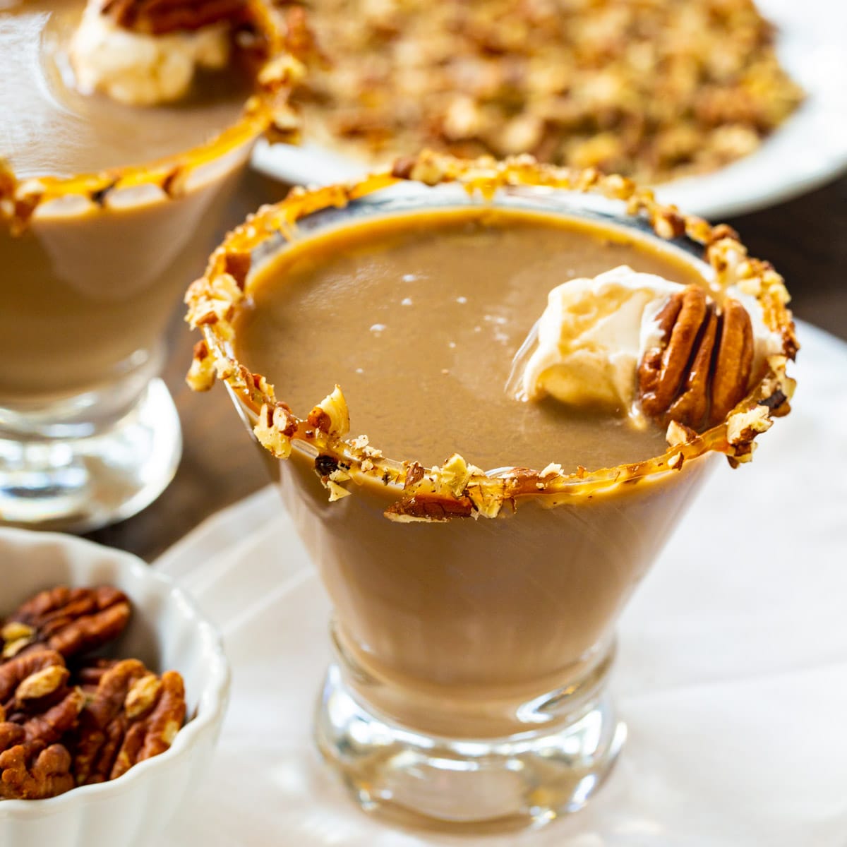 Pecan Pie Martini with caramel sauce and chopped pecans around rims.