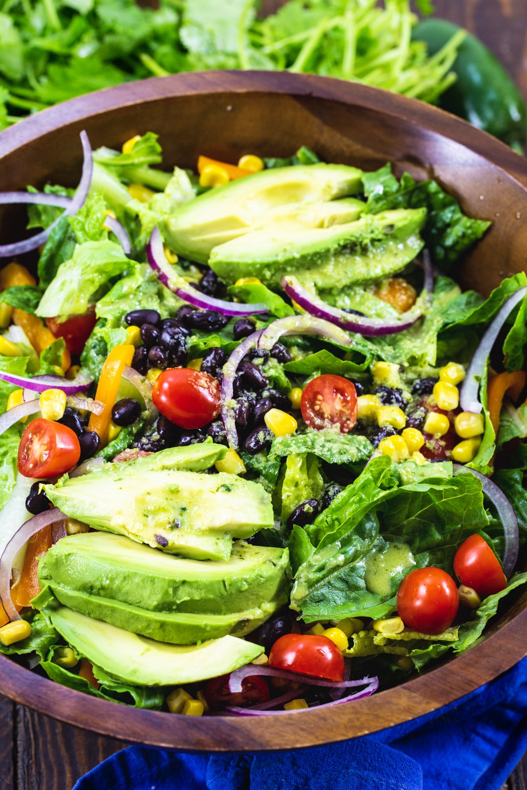Southwestern Salad with Jalapeno Lime Vinaigrette in wood bowl.