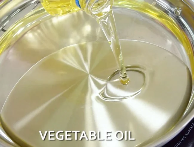 Adding oil to pan.