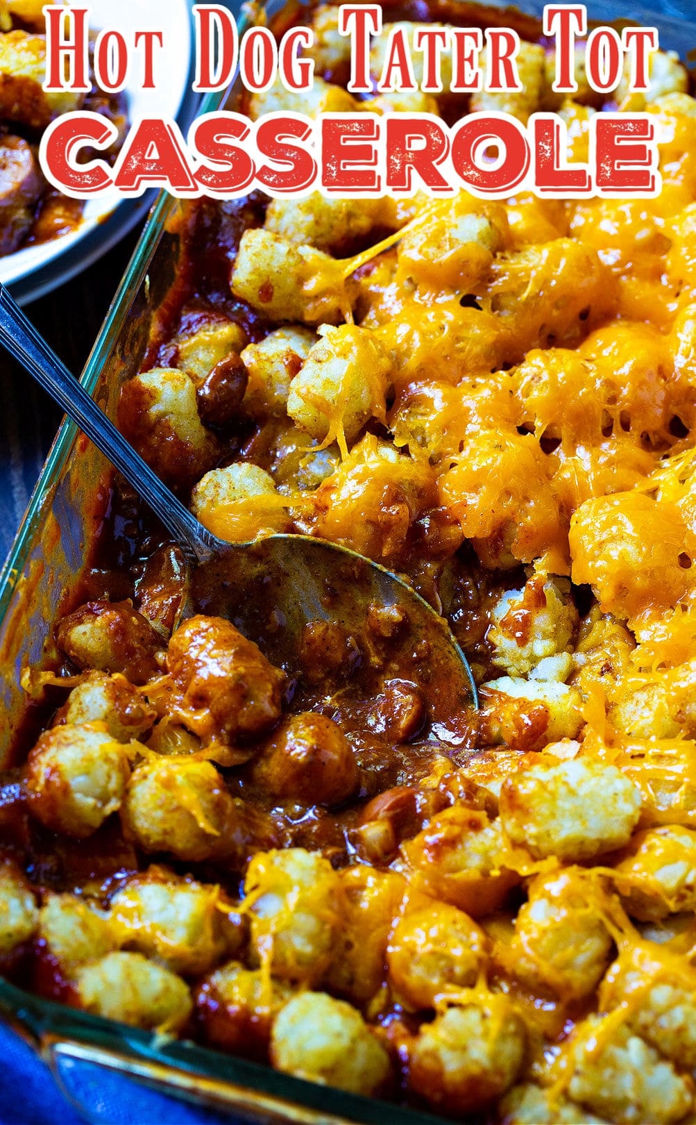 Spoon dishing up Cheesy Hot Dog Tater Tot Casserole.