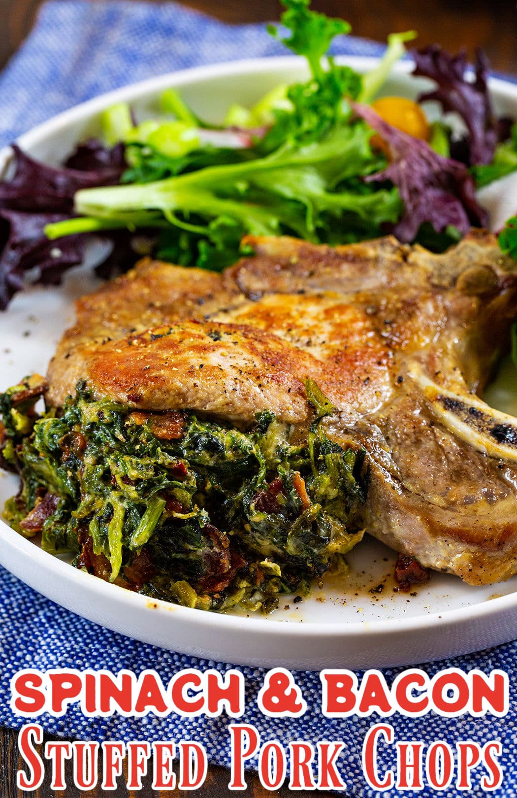 Spinach and Bacon Stuffed Pork Chop on plate with salad.