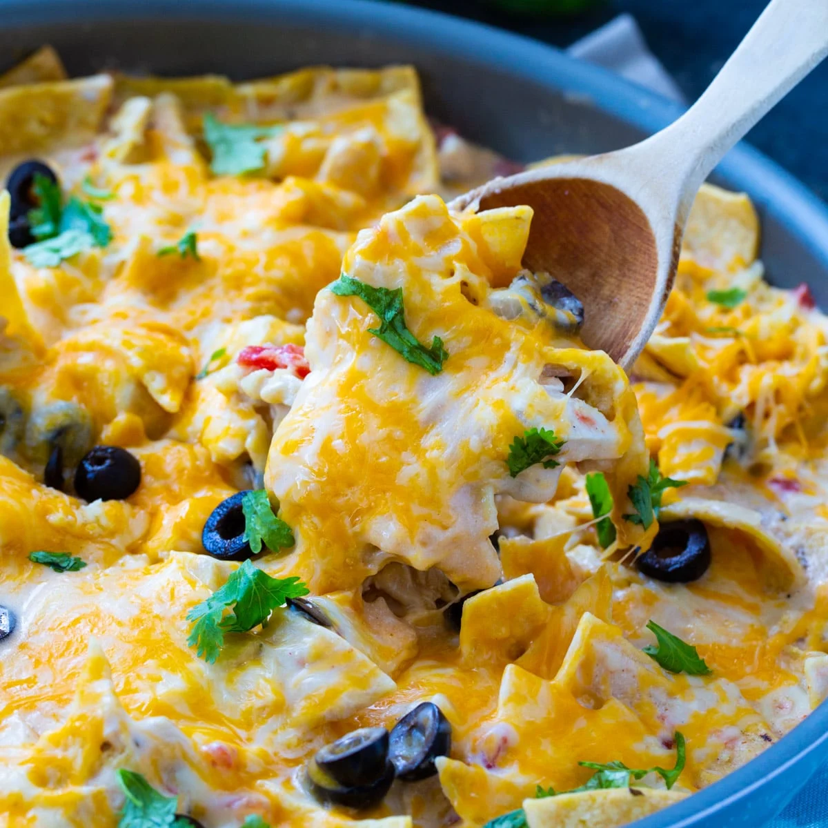 Chicken Enchilada Skillet in skillet with spoon scooping some.
