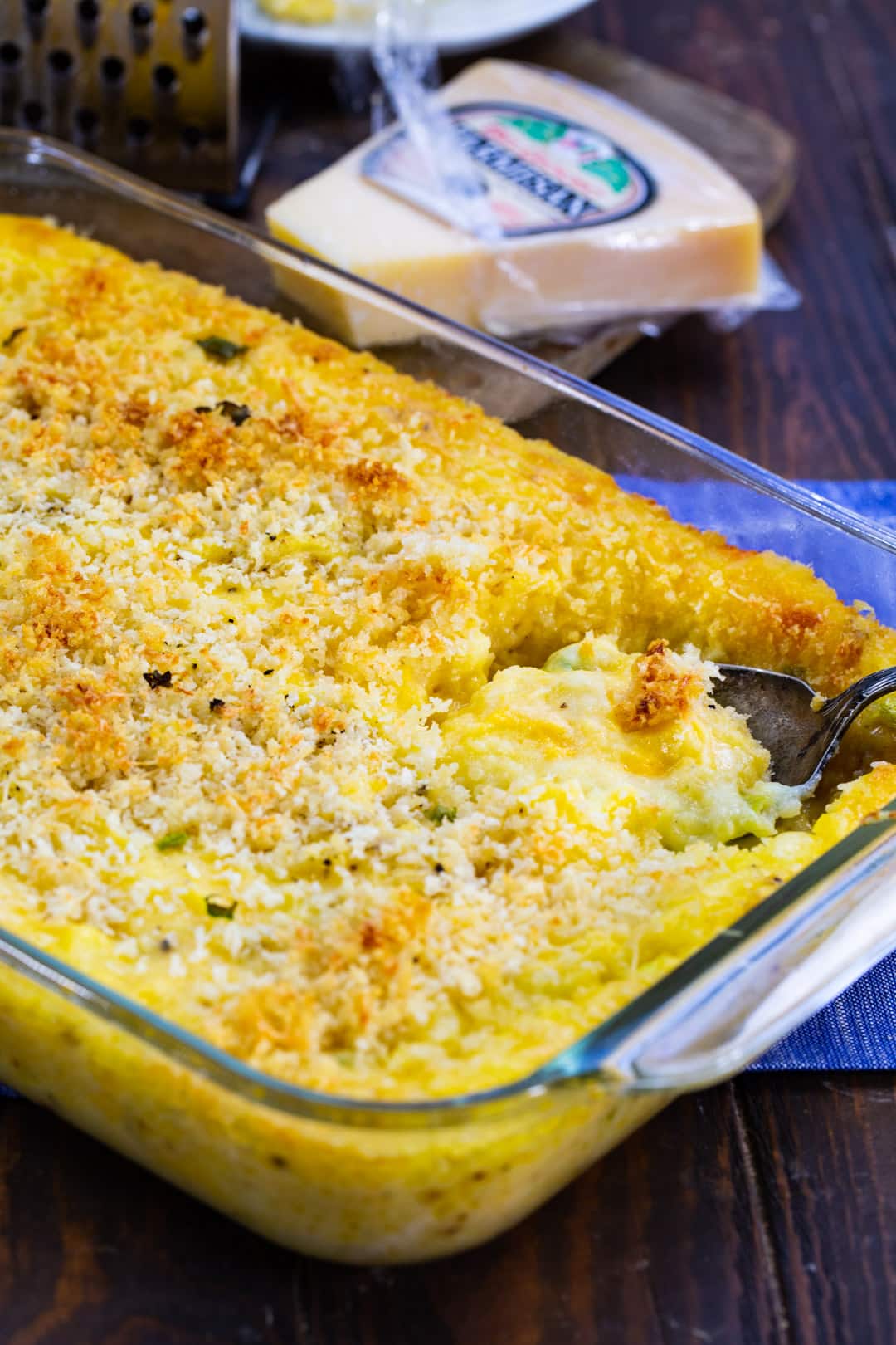 Spoon scooping casserole.