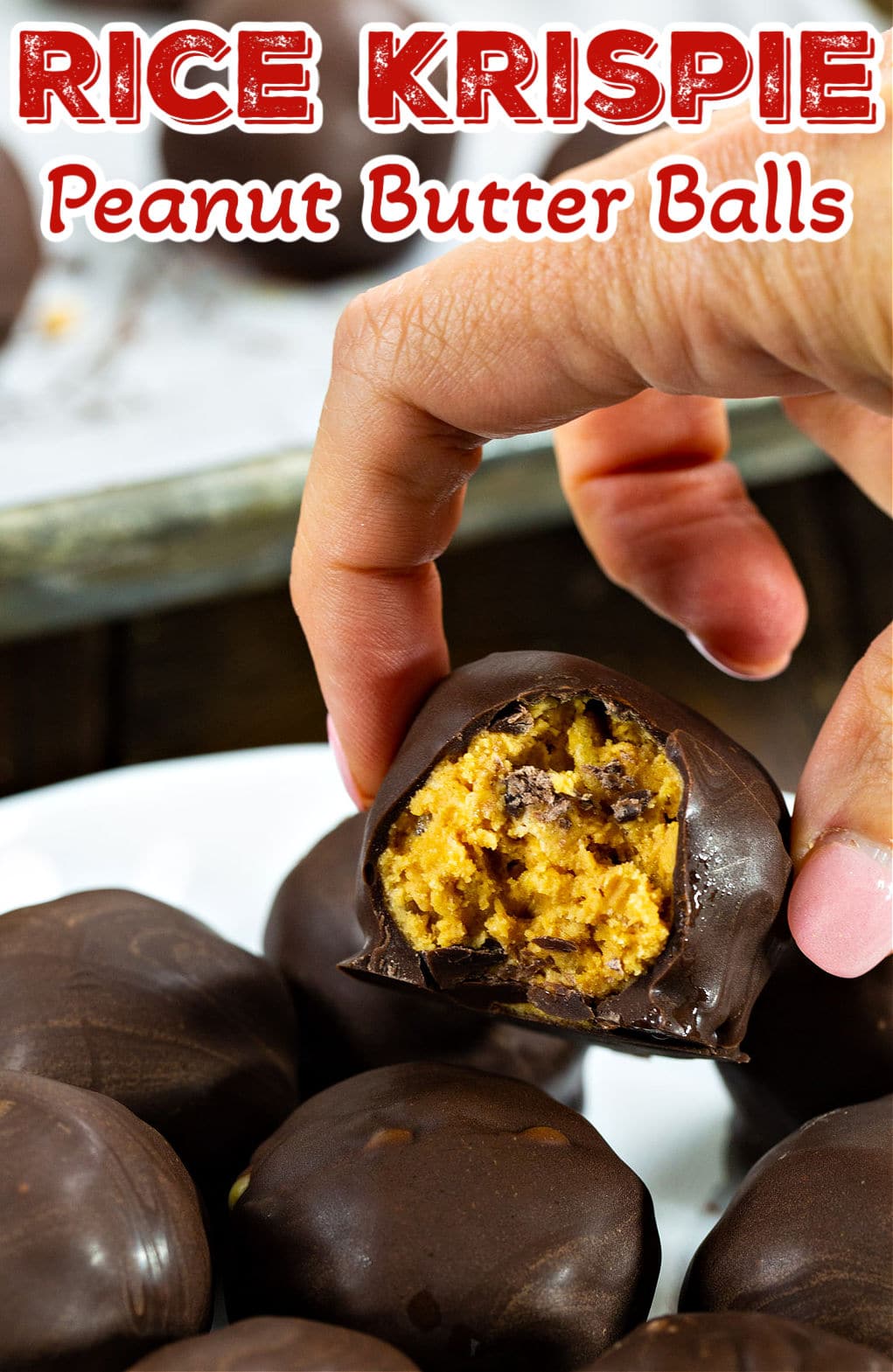 Hand picking up Rice Krispie Peanut Butter Ball.