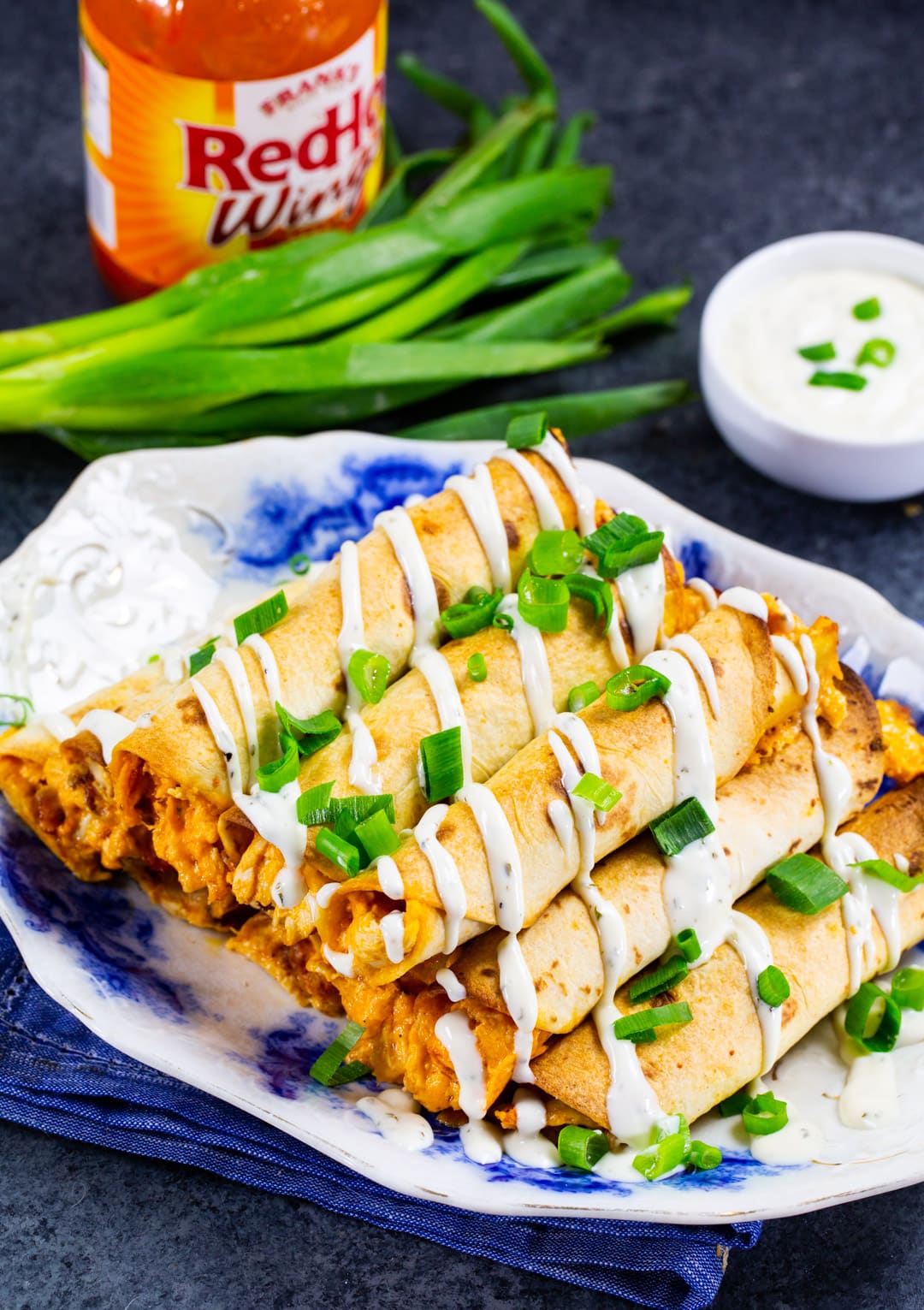 Chicken Taquitos on a plate and a bowl of ranch.