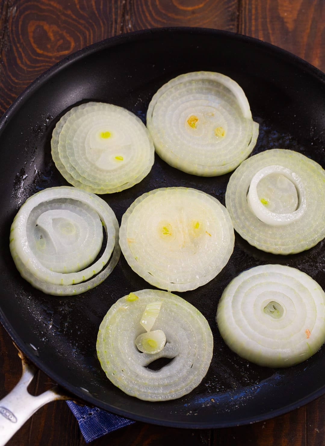 Onons being cooked in nonstick skillet.