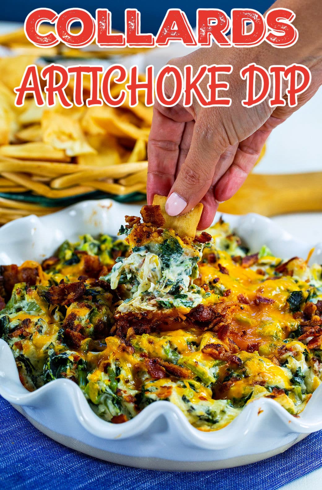 Pita chip scooping up Collards Artichoke Dip.