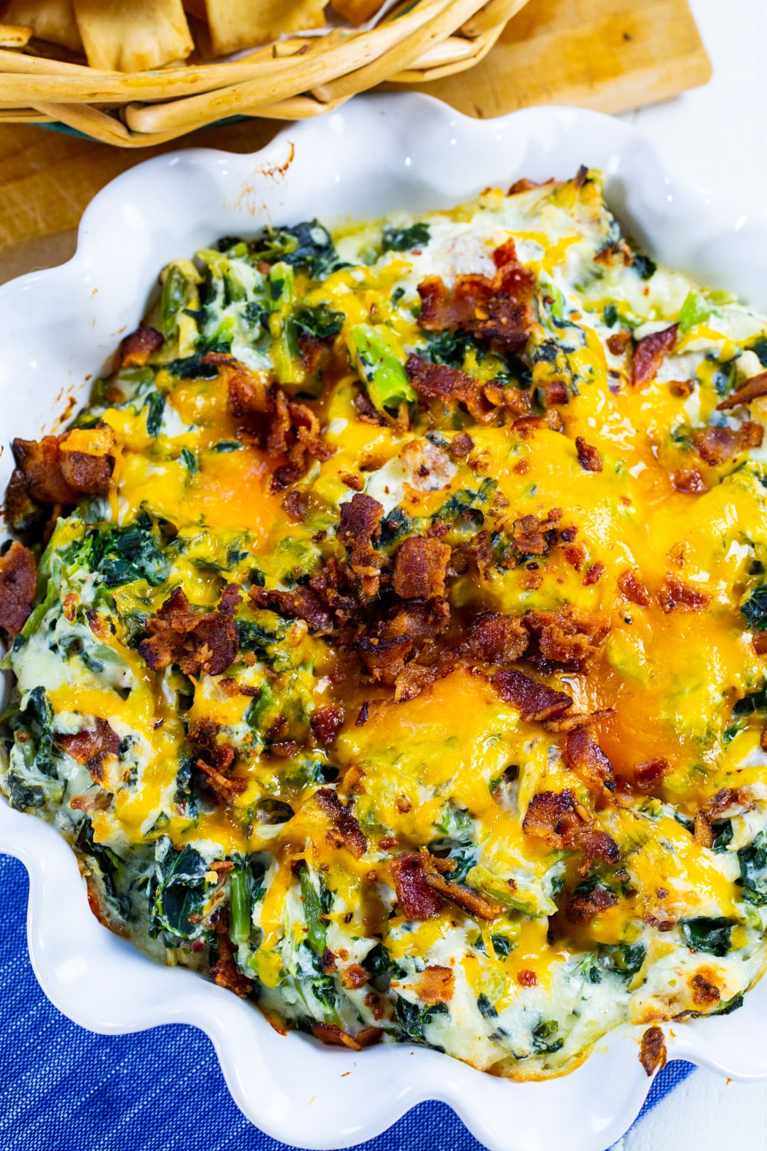 Artichoke Dip with Collards in round fluted baking dish.