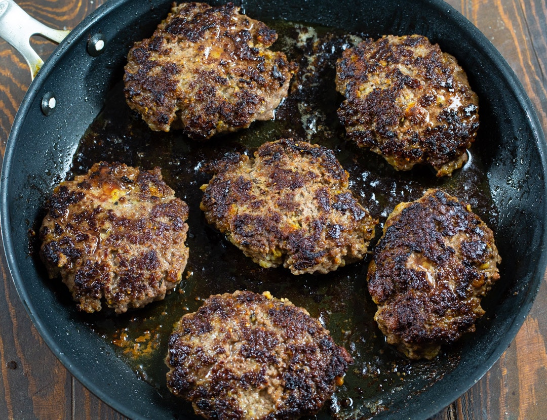 Ground Beef patties in skillet.