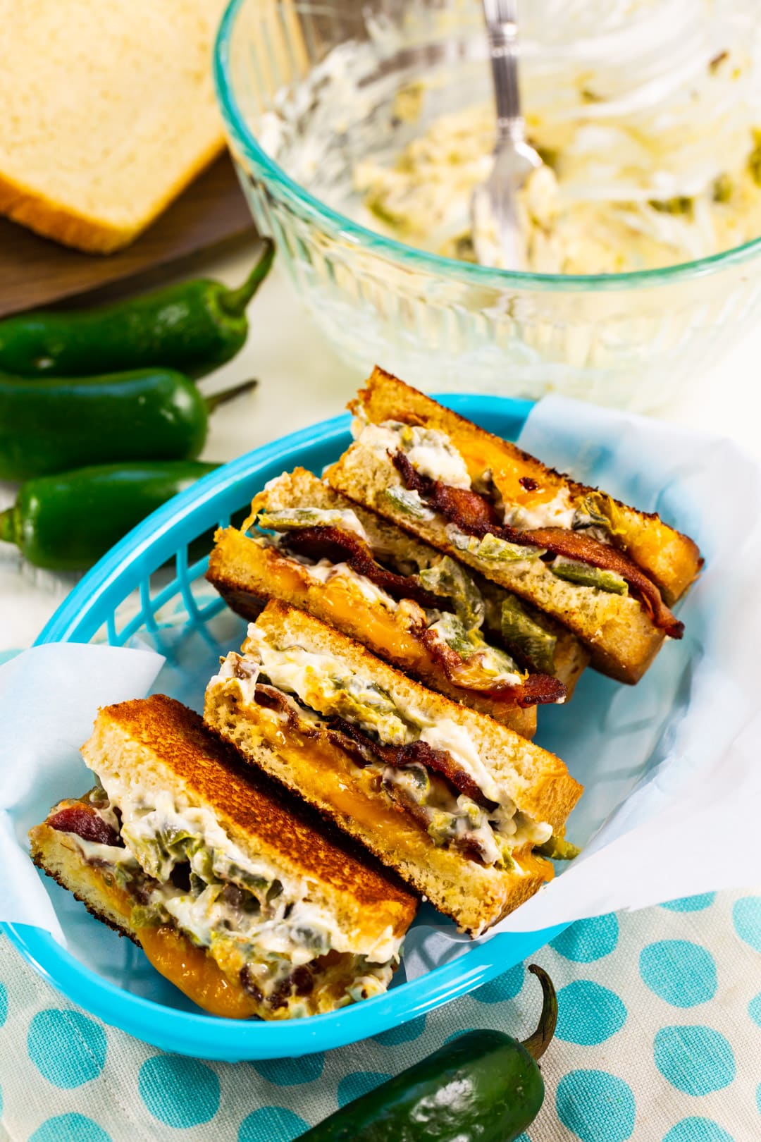 Four Grilled Cheese halves in a basket.