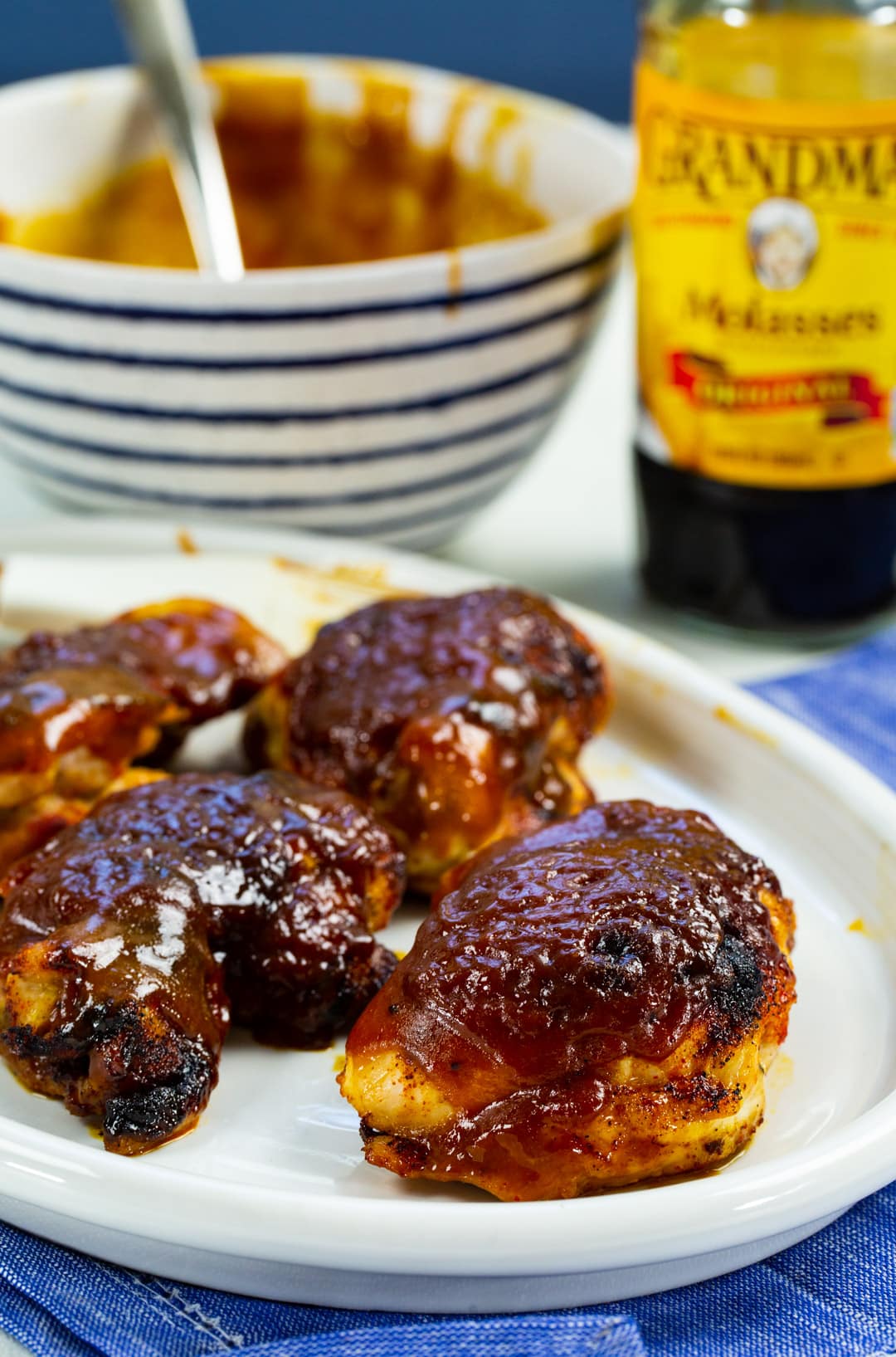 Molasses Mustard Chicken on serving plate and a bowl of glaze.