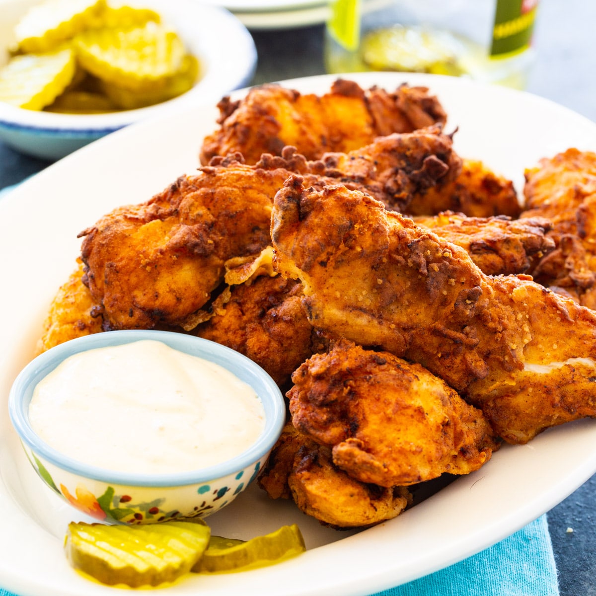Pickle-Brined Chicken Tenders on plate with small bowl of dipping sauce.