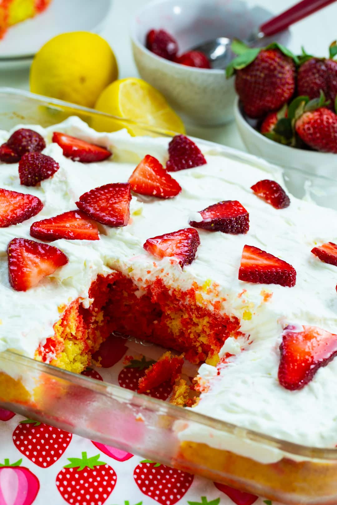 Strawberry Lemonade Poke Cake with slice removed.