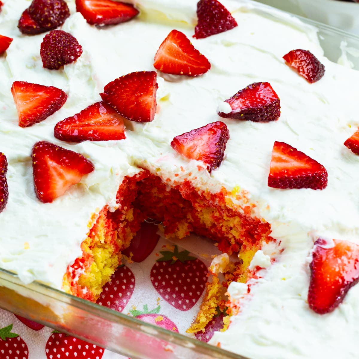 Cake in baking pan with slice removed.
