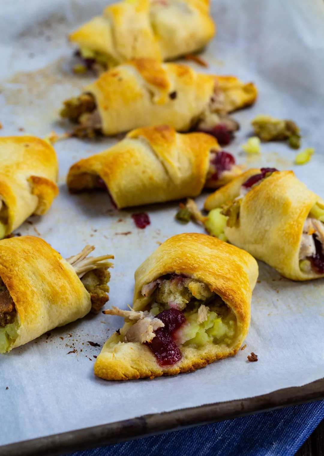Finished crescent rolls on a baking sheet.
