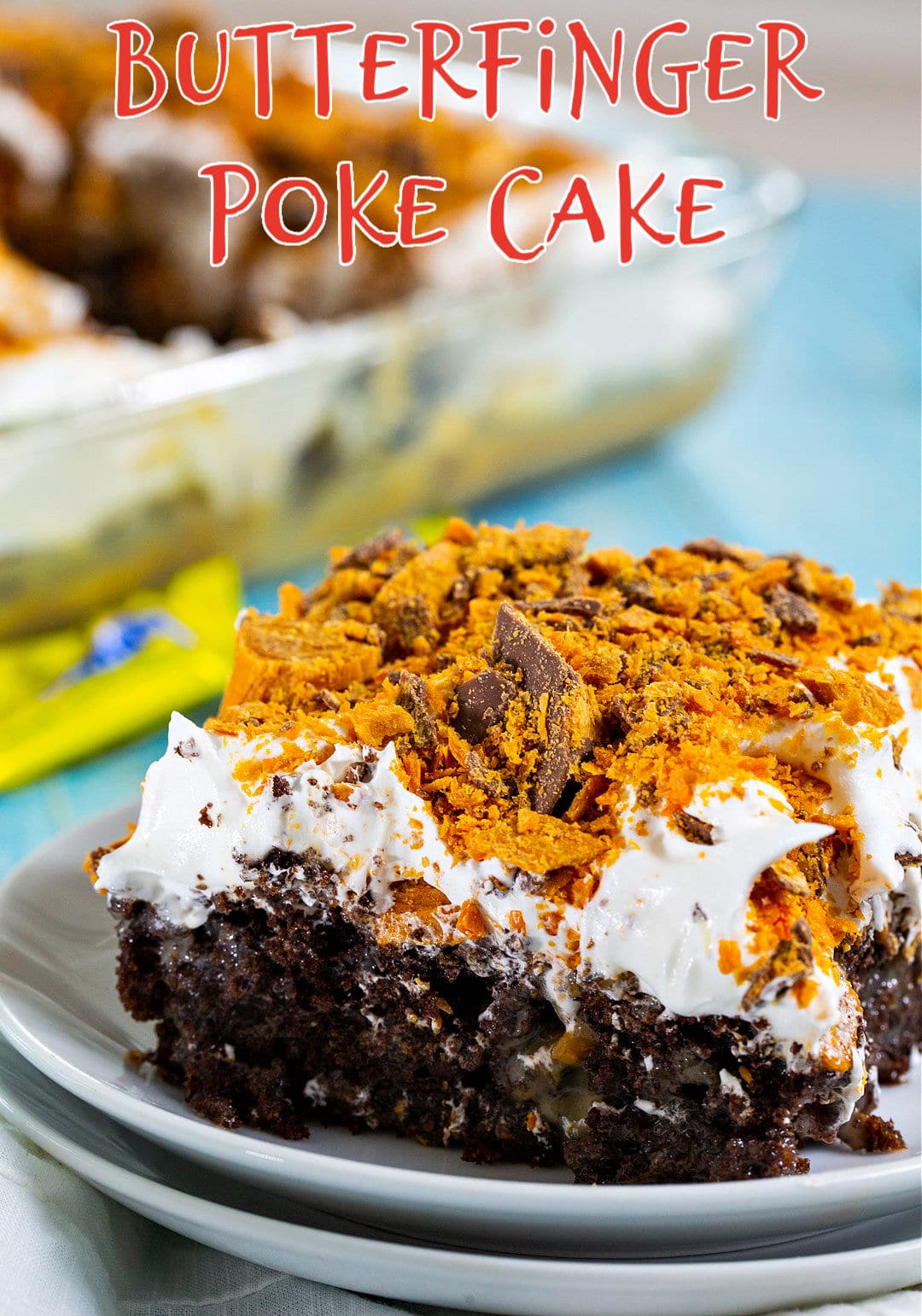 Piece of Butterfinger Poke Cake on a plate.